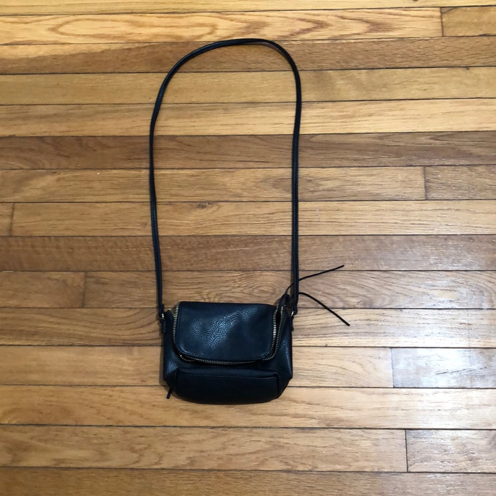 Black leather purse with gold zip and zip handle.